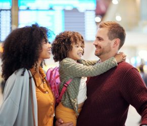 Family at airport, travel and hug with vacation, mother and father with child, ready for flight and adventure. Terminal, journey and holiday with black woman, man and kid, excited and interracial.